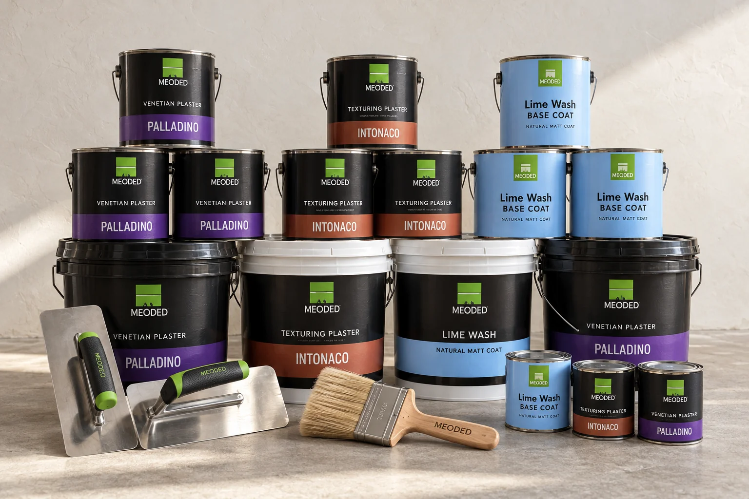 Meoded plaster supplies: Palladino Venetian plaster, Intonaco, Lime Wash and Lime Wash Base Coat cans and pails with trowels and a limewash brush
