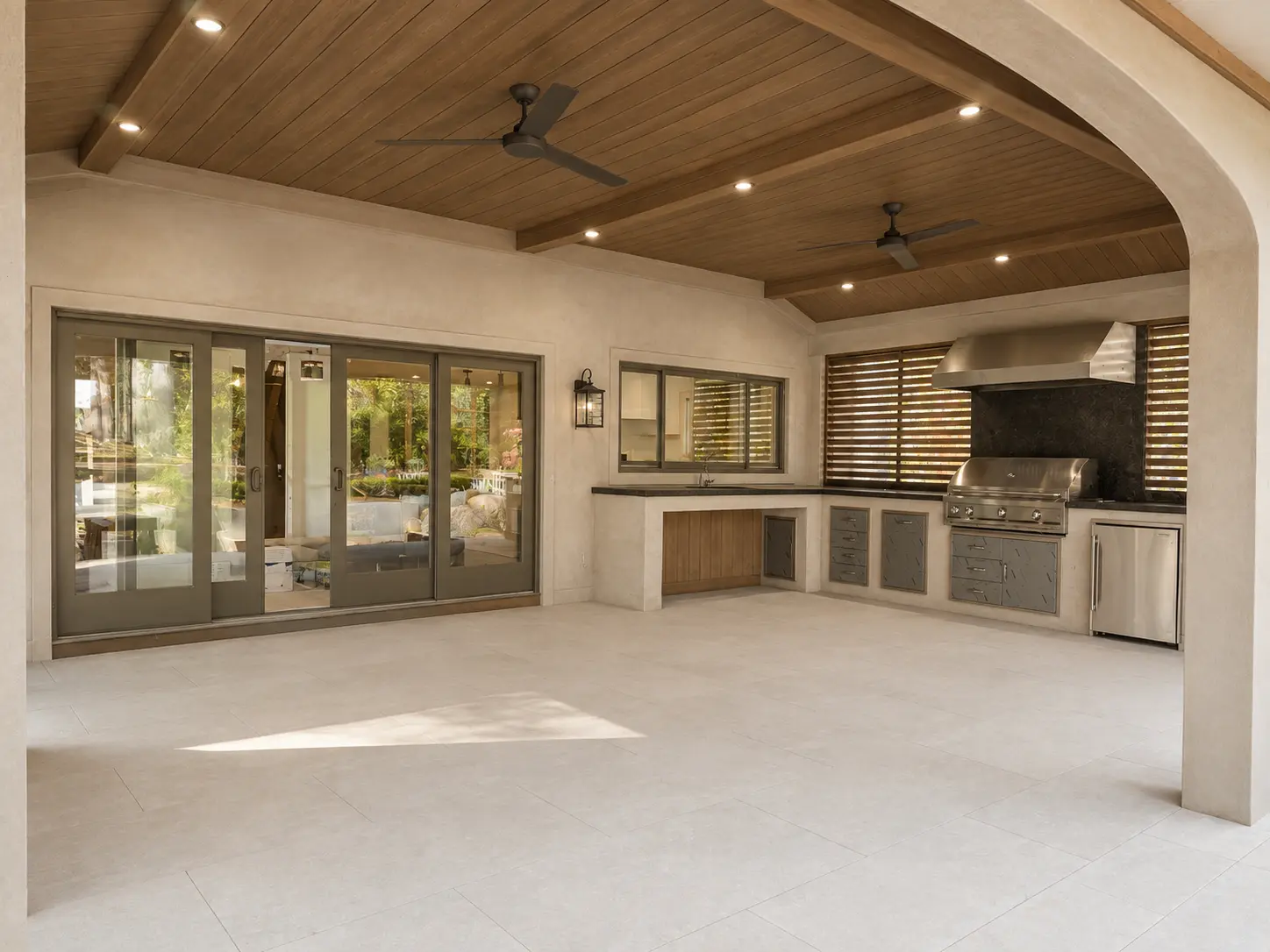 Covered outdoor kitchen with stained exterior plaster and wood ceiling in Wayne, NJ