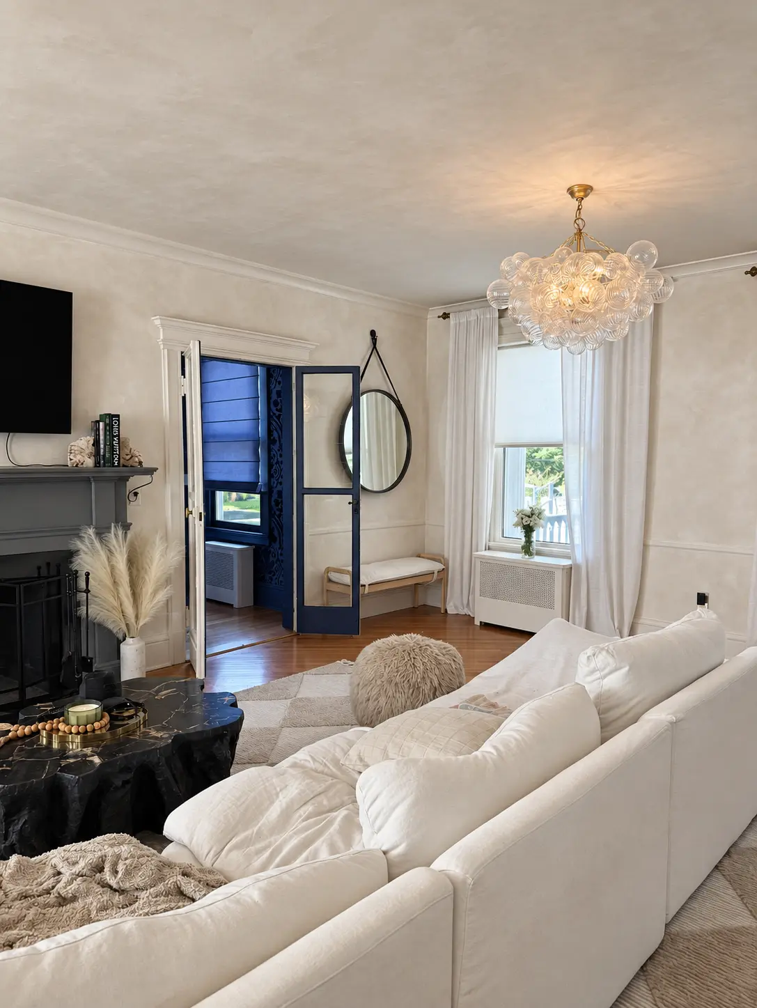 Finished living room featuring warm neutral limewash walls and ceiling with subtle handcrafted movement