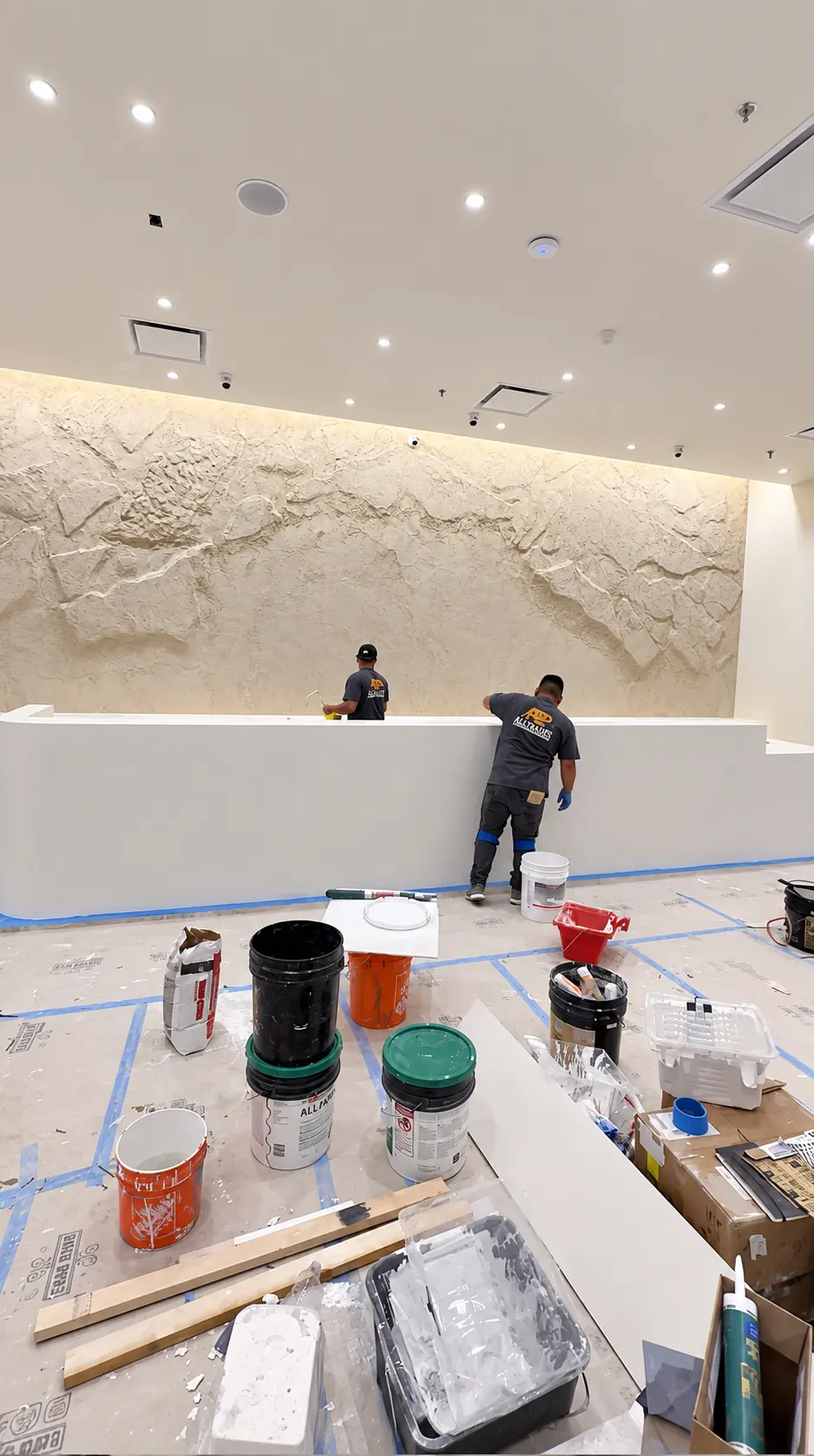 Wide view of the Veiled flagship store interior in Clifton, NJ with the microcement checkout counter in front of the sculptural feature wall