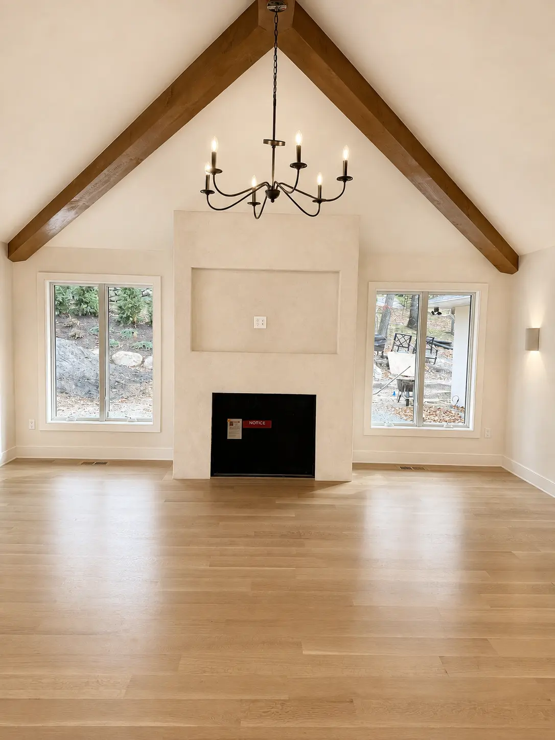 Vaulted great room with lime plaster fireplace and stained timber ceiling beams in Wayne, NJ