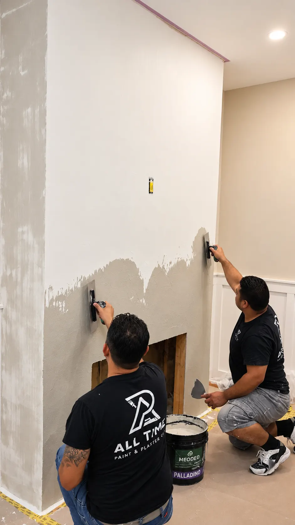 Craftsman hand-troweling the finish coat of Meoded Palladino plaster on a fireplace