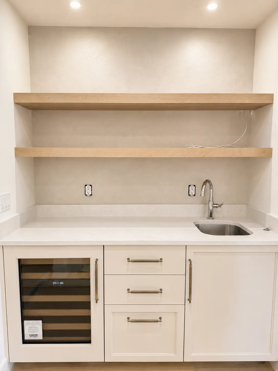 Microcement wet bar niche with oak shelving in Wayne, NJ