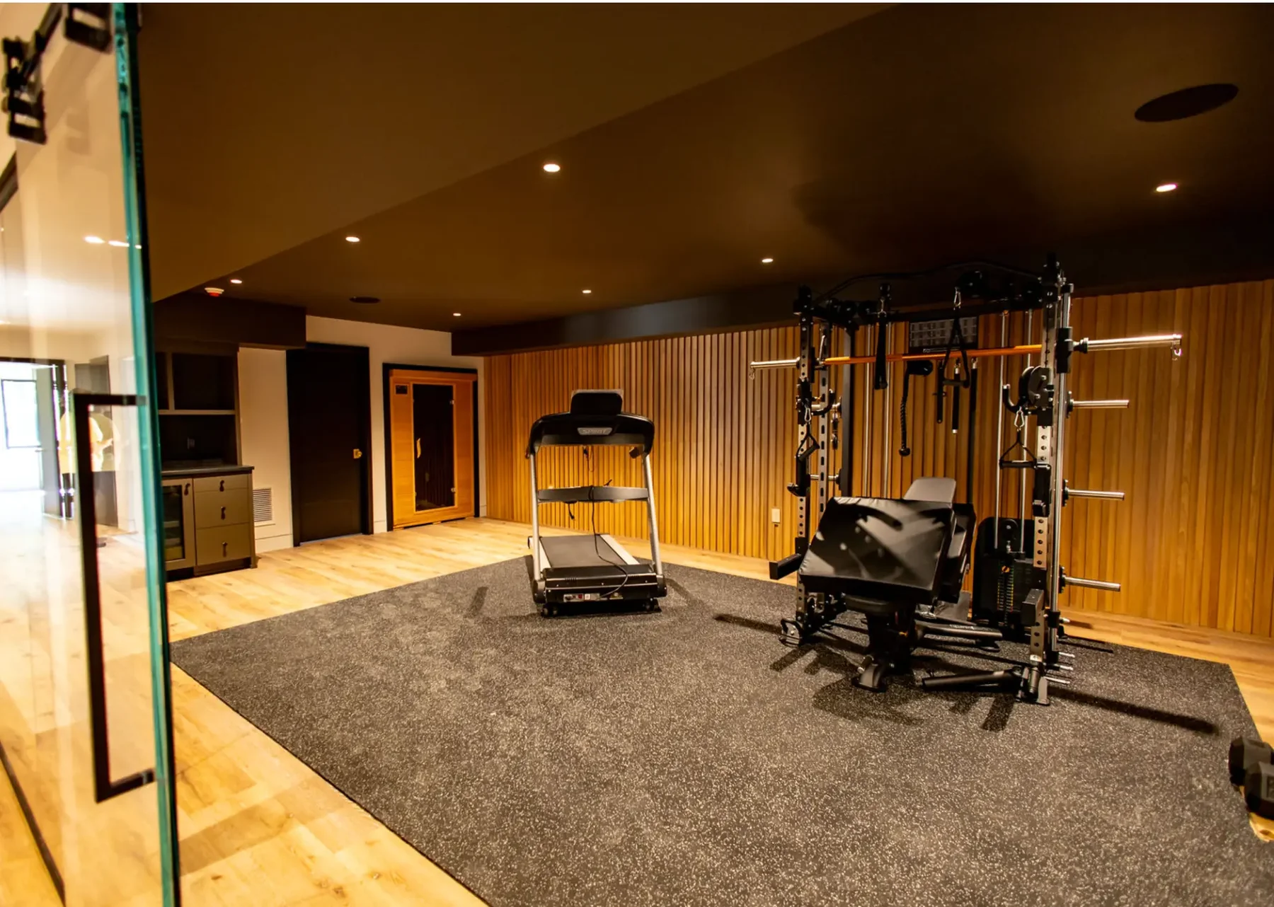 Home gym with slat wood accent wall and stained ceiling in Pompton Plains, NJ