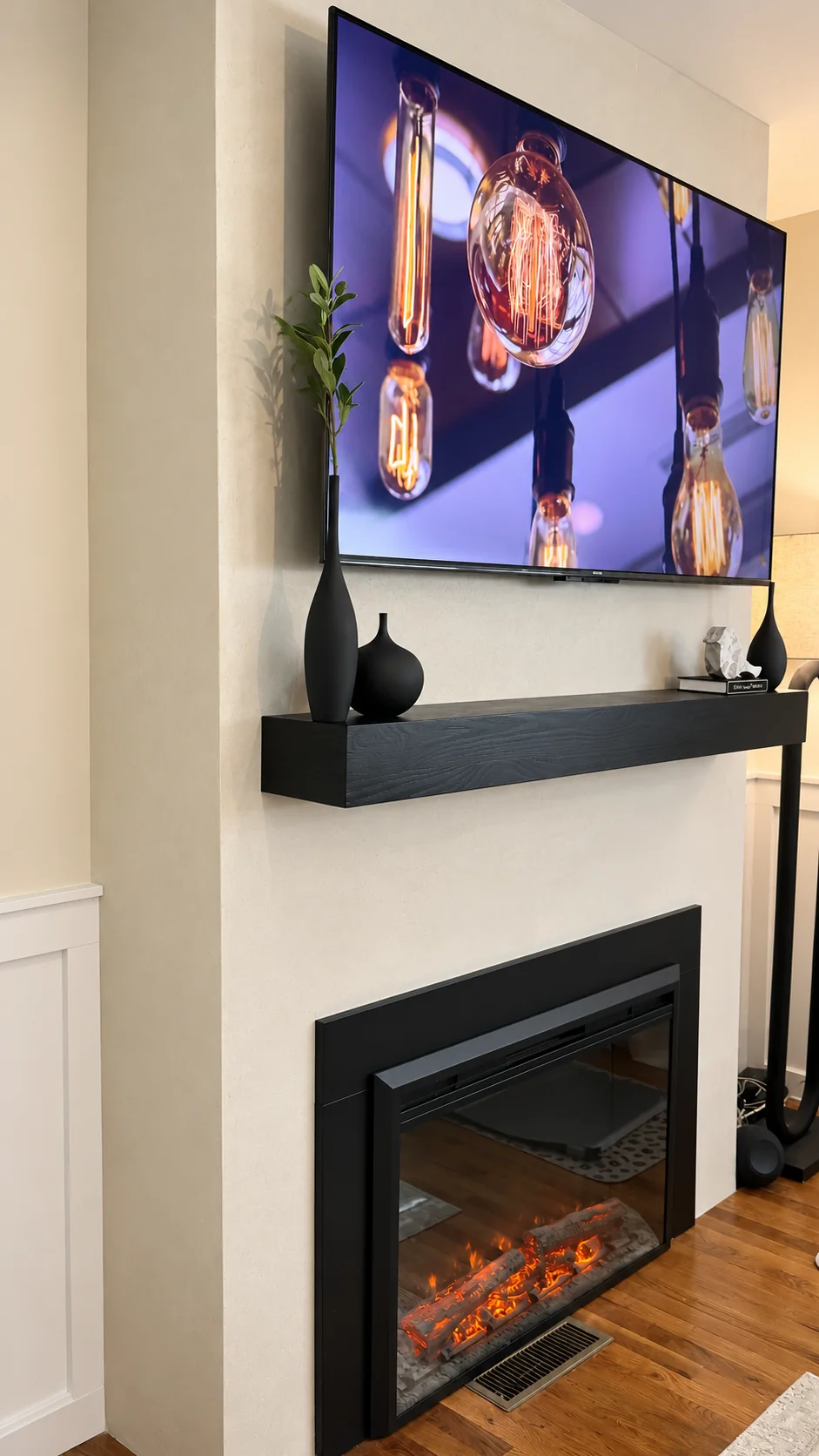 Modern lime plaster fireplace in a Cedar Grove, NJ living room with black mantel