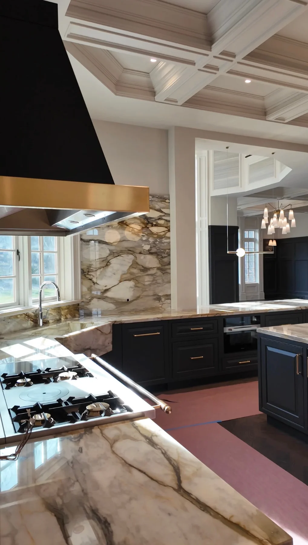 Painted coffered ceiling and walls in a kitchen with marble counters in Alpine, NJ