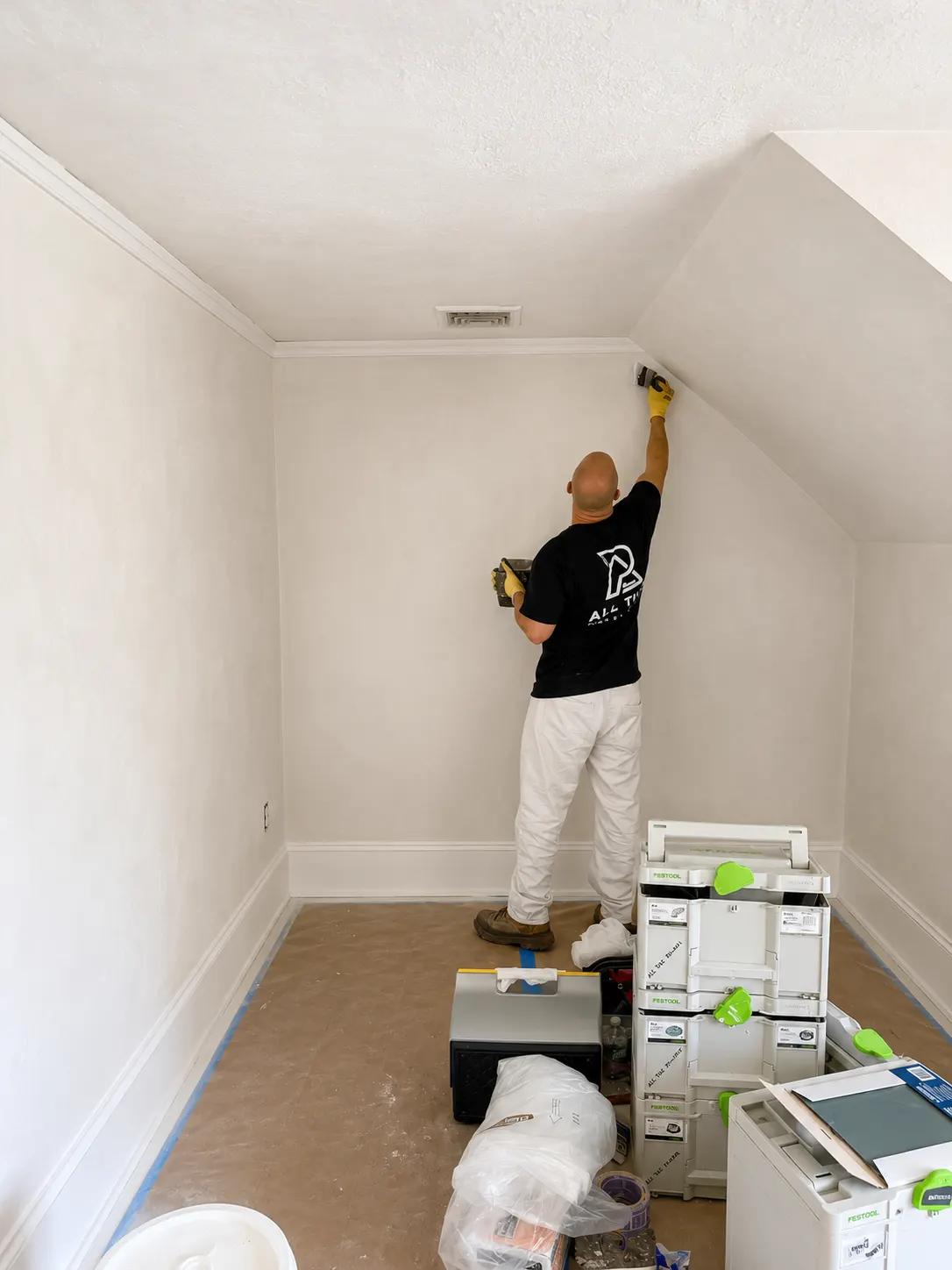 Painter smoothing and preparing an interior wall before a decorative finish in New Jersey