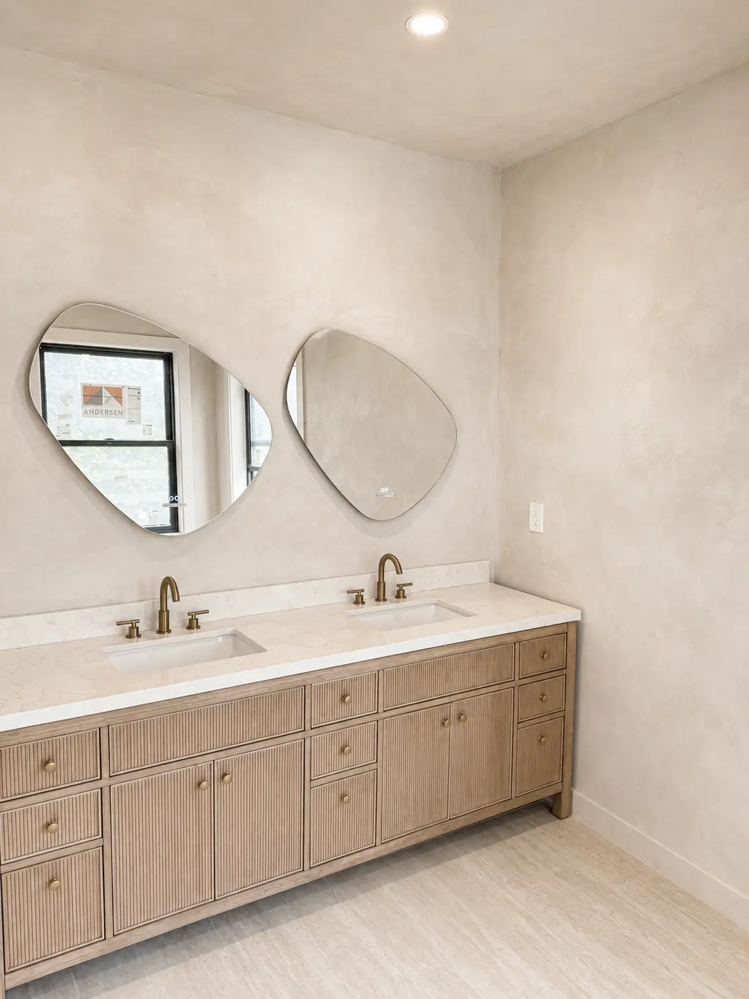 Sand-toned microcement walls above a fluted double vanity in Clifton, NJ