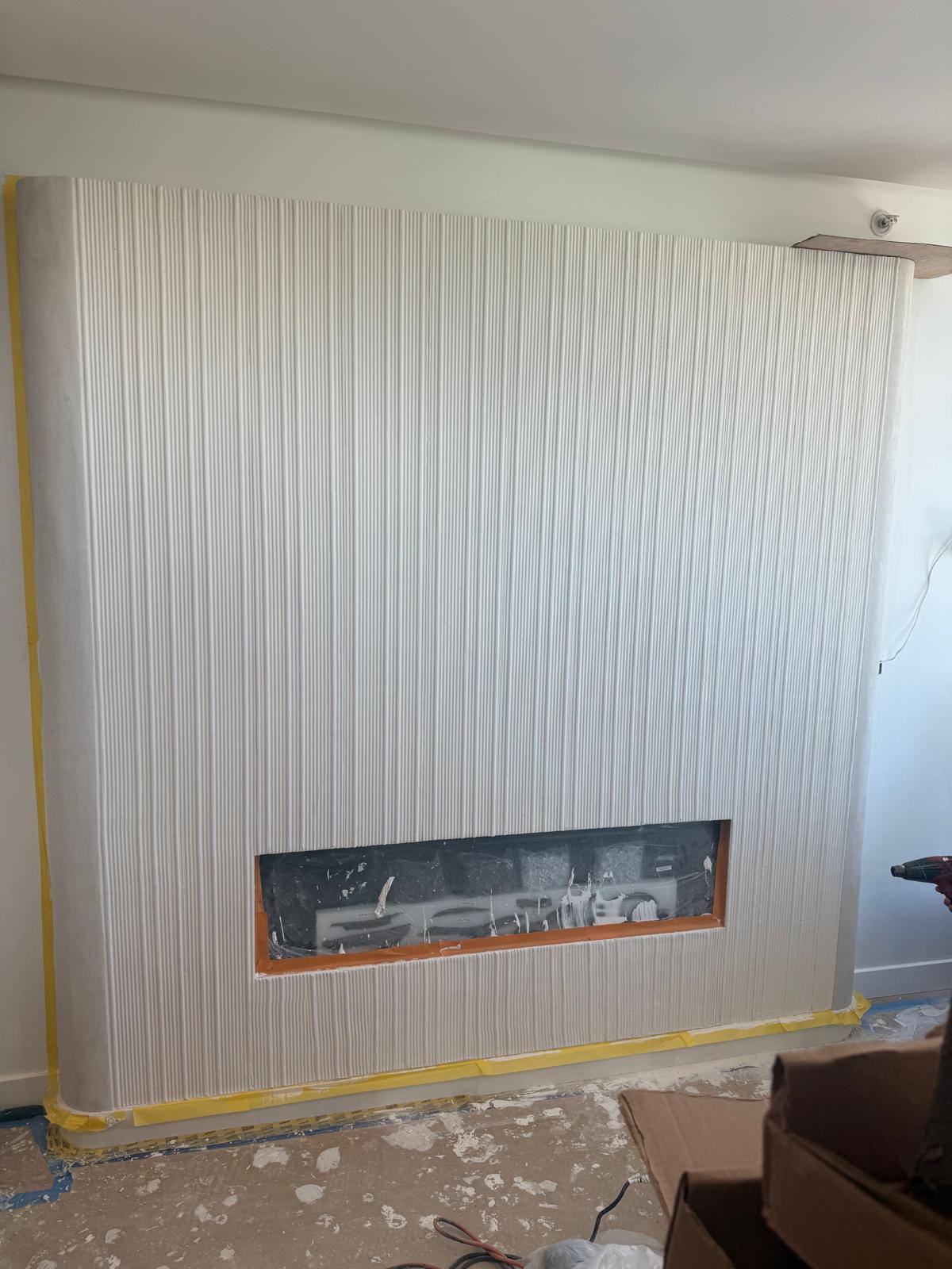 Full-height fluted Meoded Intonaco plaster fireplace with continuous vertical flutes in New Jersey