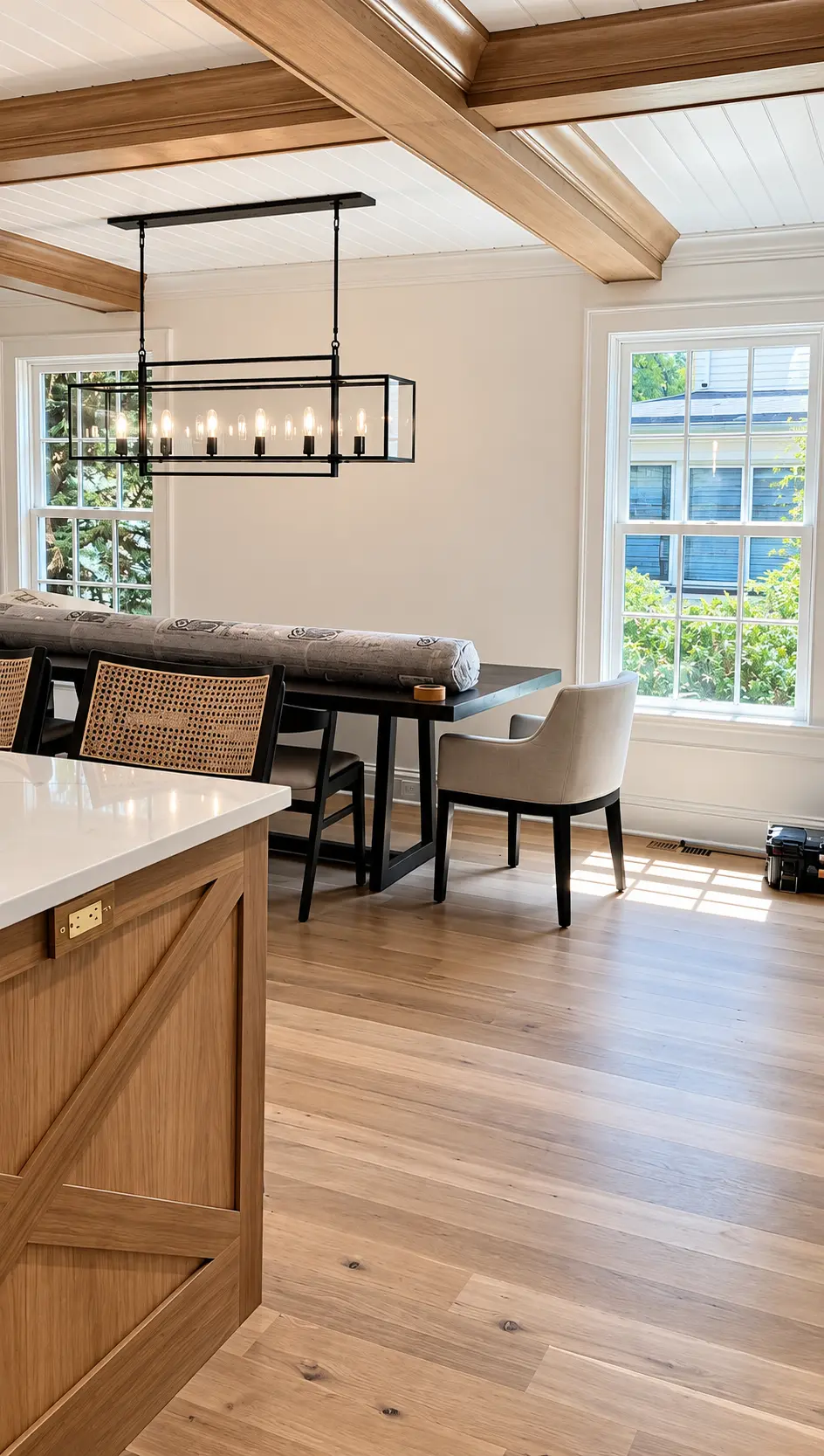 Finished natural wood ceiling beams in a sunlit dining nook