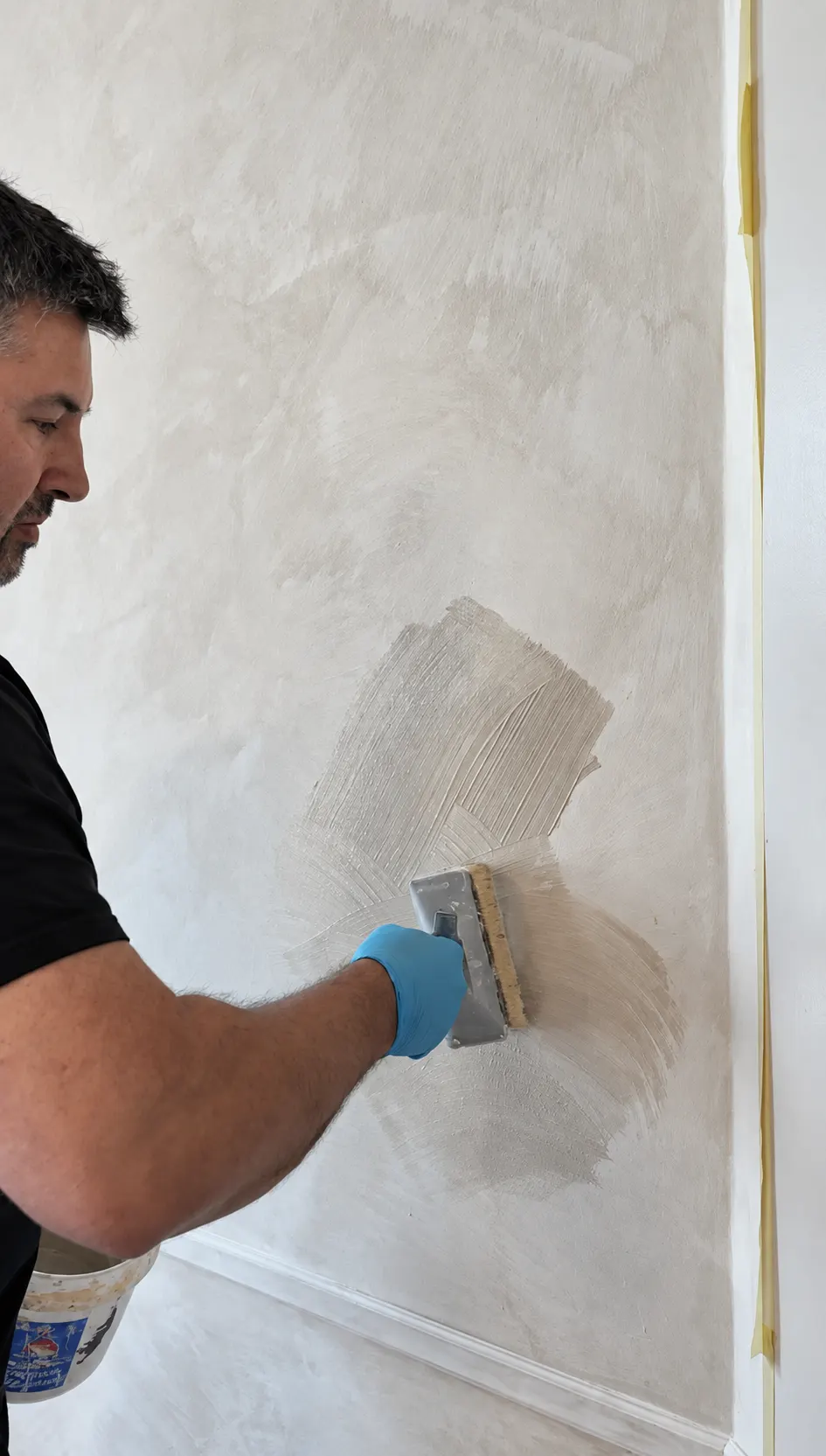 All Time Paint & Plaster craftsman applying limewash with a specialty block brush in overlapping multidirectional strokes on an interior wall in North Jersey
