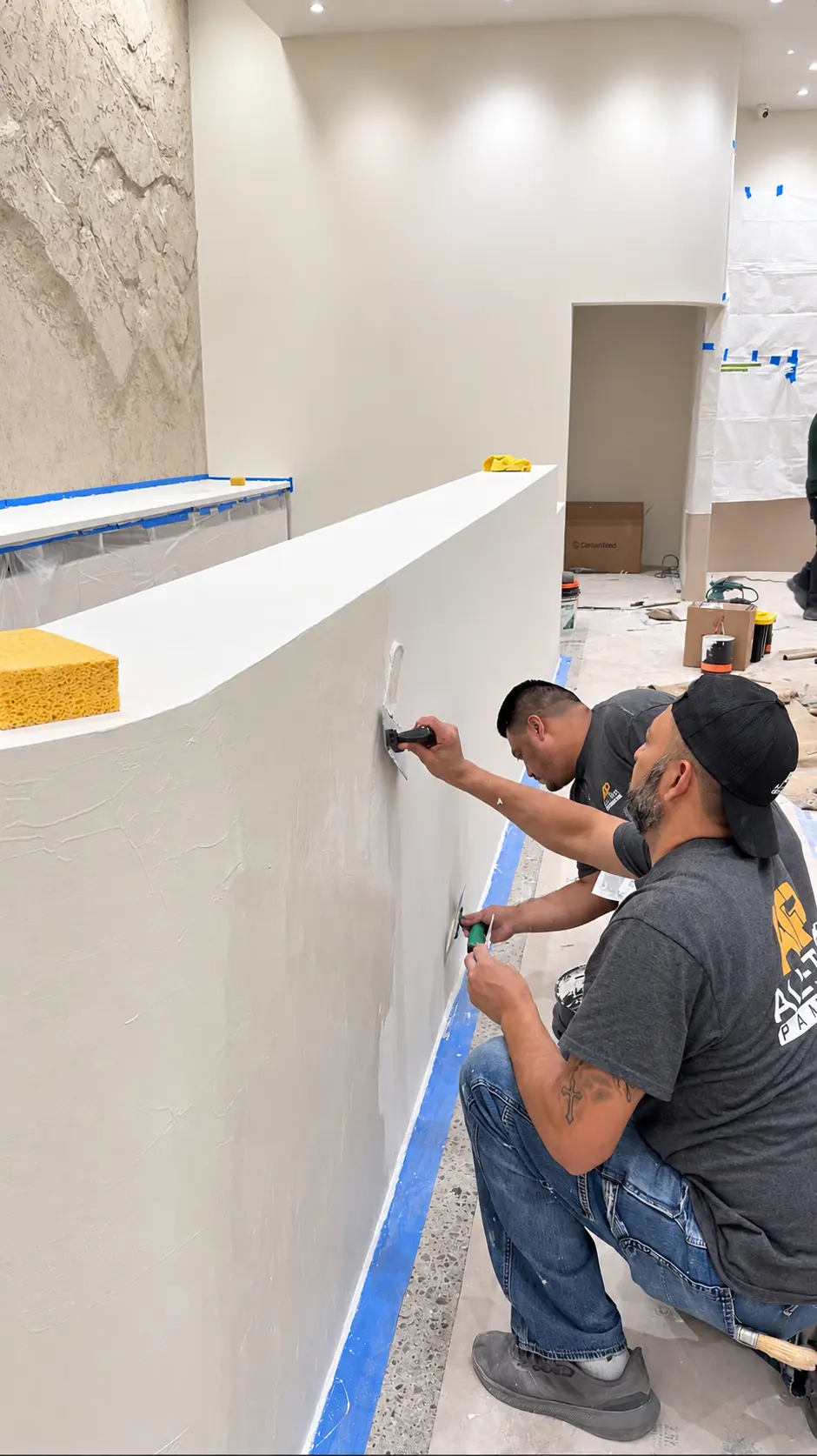 All Time Paint & Plaster crew hand-troweling Meoded Concretta FS microcement onto the retail checkout counter in Clifton, New Jersey